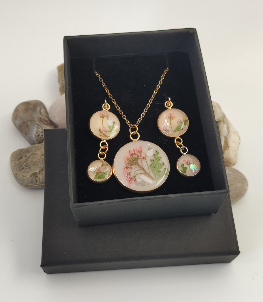 Elegant handcrafted green resin jewelry collection showcasing artisanal necklaces and bracelets in premium packaging