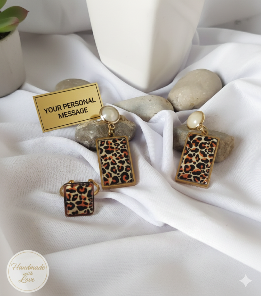 Handmade leopard print jewelry set with stainless steel ring and stud earrings in a premium gift box featuring a personalized gold mirror acrylic plaque inside.